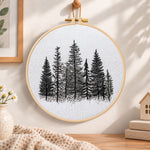 Monochrome pine woods embroidery hoop wall art displayed as warm and cozy handmade home decor