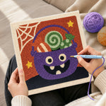 Creating handmade monster candy bucket punch needle artwork