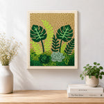 Finished monstera, ferns and succulents artwork displayed on a wall