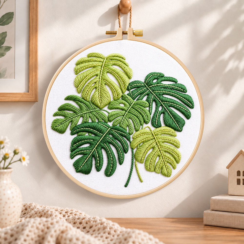 Monstera leaf embroidery hoop wall art displayed as warm and cozy handmade home decor