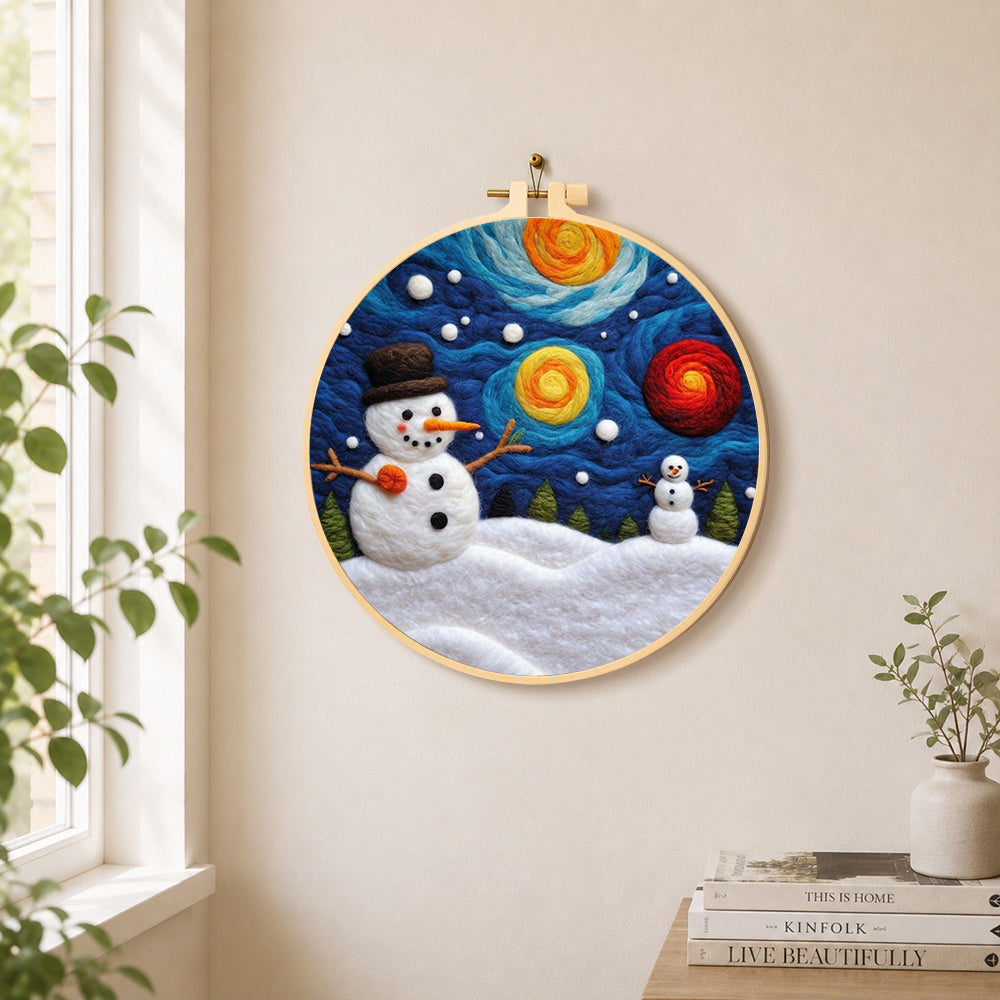 Moon and snowman under the starry sky needle felt wall art displayed in a bright home interior