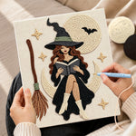 Creating handmade moon witch reading a book punch needle artwork