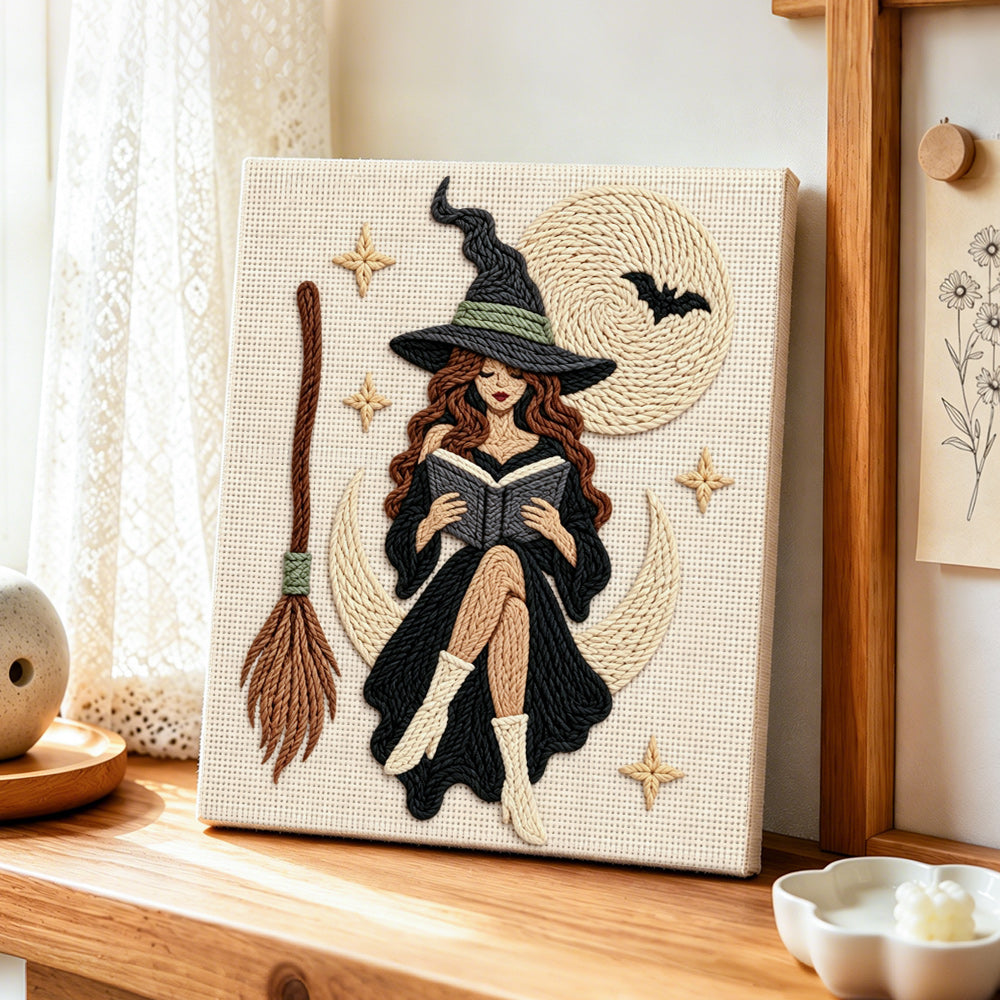 Moon witch reading a book punch needle artwork displayed on a table