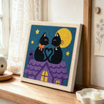Moonlight cat love punch needle artwork displayed on a table