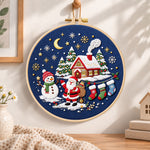 Moonlight christmas scene embroidery hoop wall art displayed as warm and cozy handmade home decor