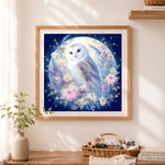 Finished moonlit floral owl cross stitch artwork displayed as home decor
