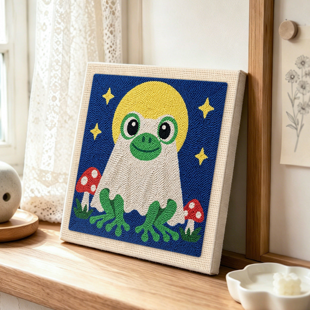 Moonlit frog ghost punch needle artwork displayed on a table