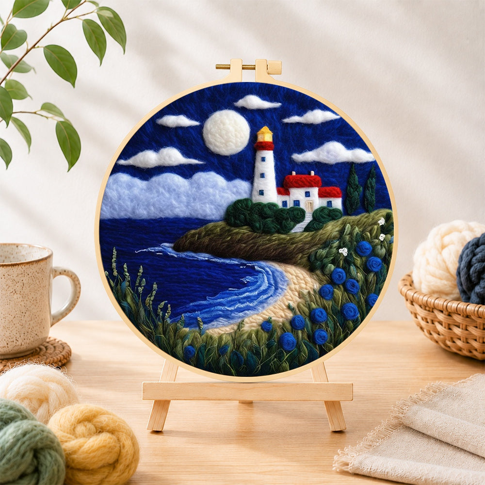 Finished moonlit white lighthouse and blue roses needle felting displayed on a wooden easel