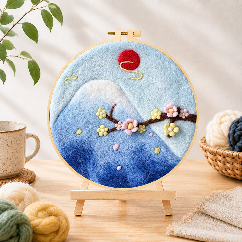 Finished mount fuji and cherry blossom needle felting displayed on a wooden easel