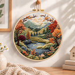 Mountain lake autumn landscape embroidery hoop wall art displayed as warm and cozy handmade home decor