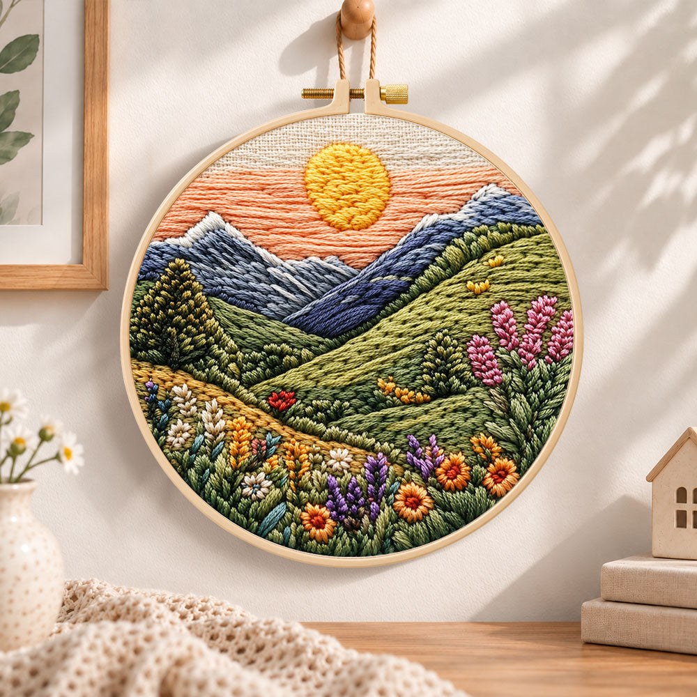 Mountain sunset meadow embroidery hoop wall art displayed as warm and cozy handmade home decor