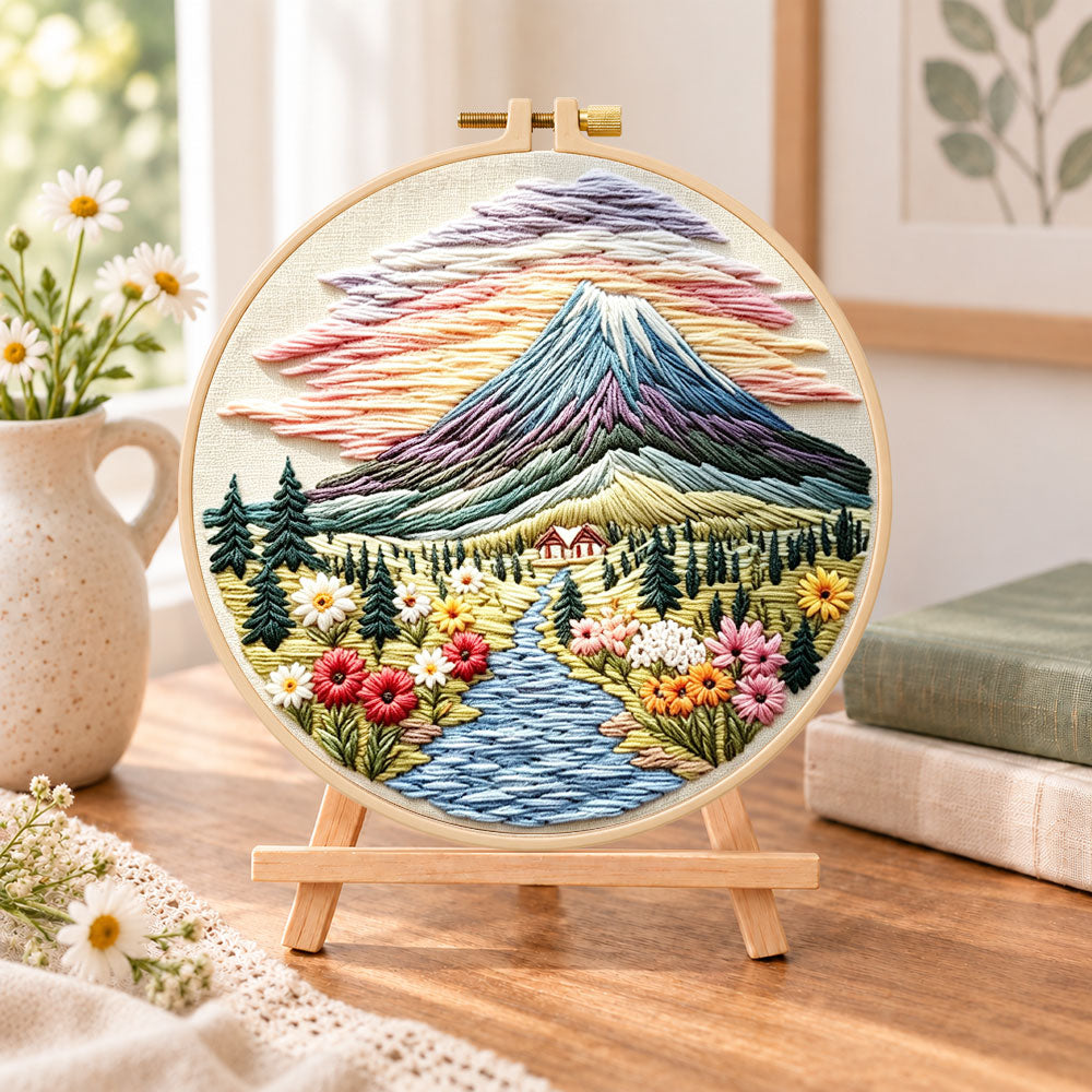 Mountain sunset scenery embroidery kit finished hoop displayed on a wooden stand as cozy tabletop decor