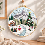 Mountain winter wonderland embroidery hoop wall art displayed as warm and cozy handmade home decor