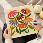 Creating handmade multicolor daisies punch needle artwork