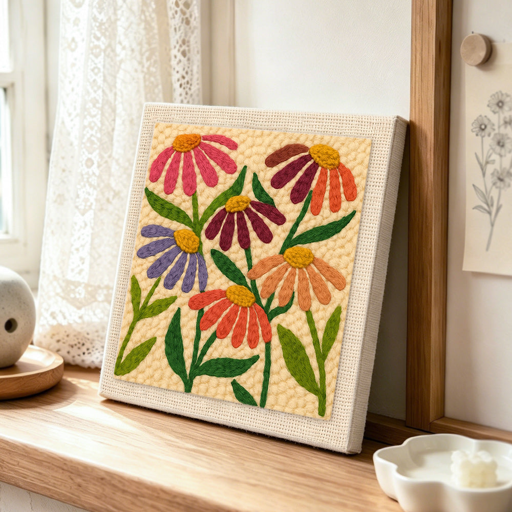 Multicolor daisies punch needle artwork displayed on a table