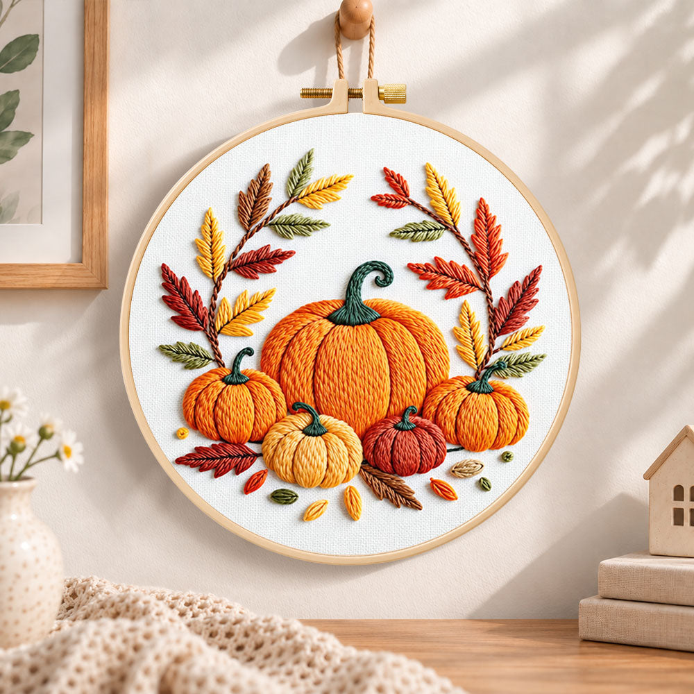 Multiple pumpkins with autumn leaves embroidery hoop wall art displayed as warm and cozy handmade home decor