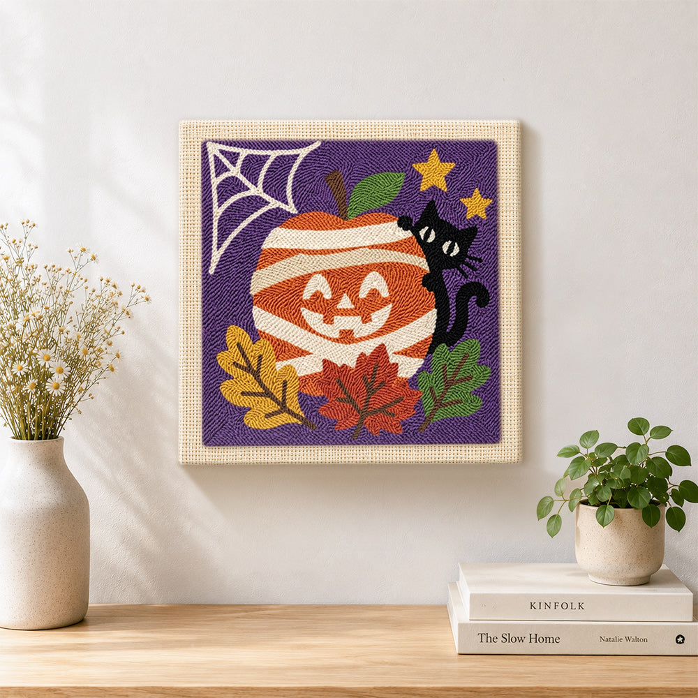 Finished mummy apple and black cat artwork displayed on a wall