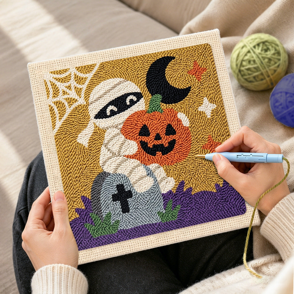 Creating handmade mummy holding pumpkin punch needle artwork