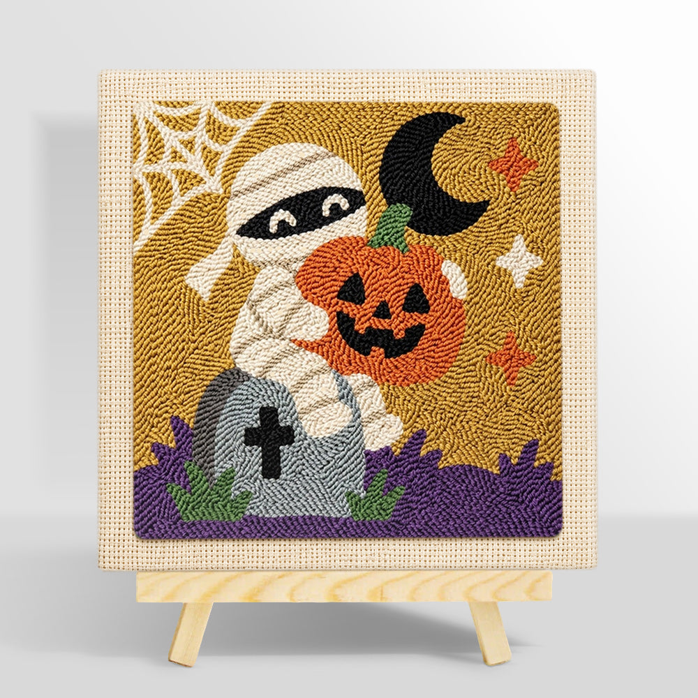 Mummy holding pumpkin punch needle kit for beginners