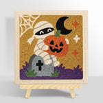 Mummy holding pumpkin punch needle kit for beginners