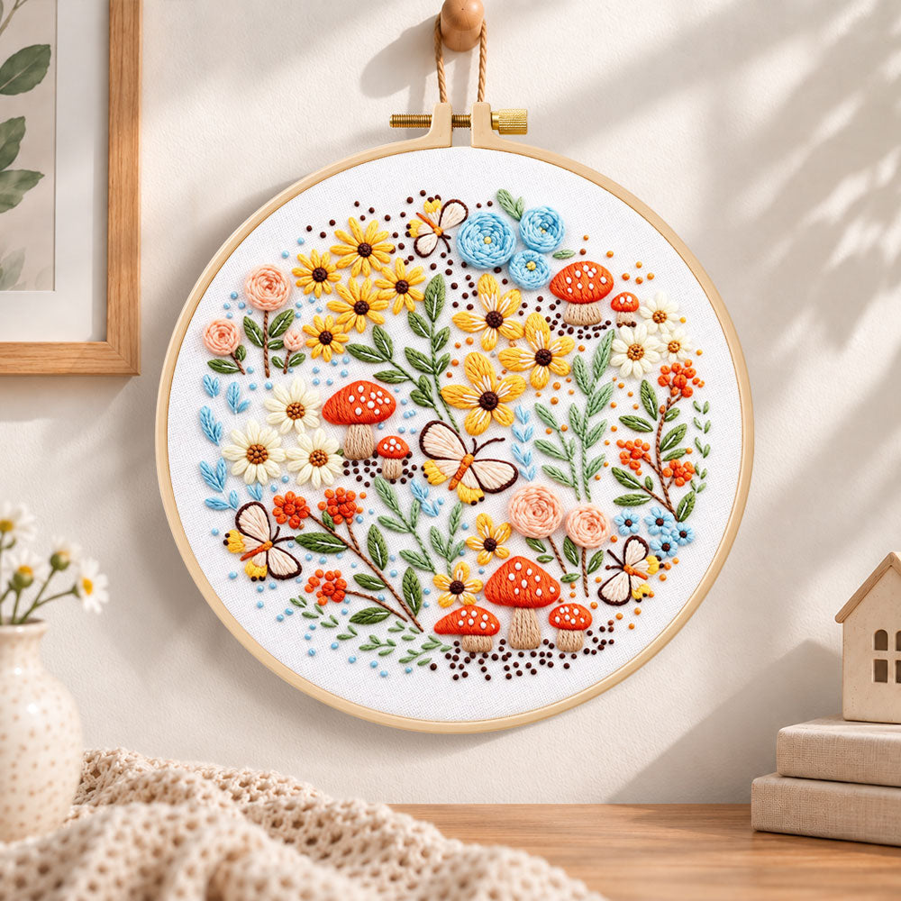 Mushroom and butterfly garden embroidery hoop wall art displayed as warm and cozy handmade home decor