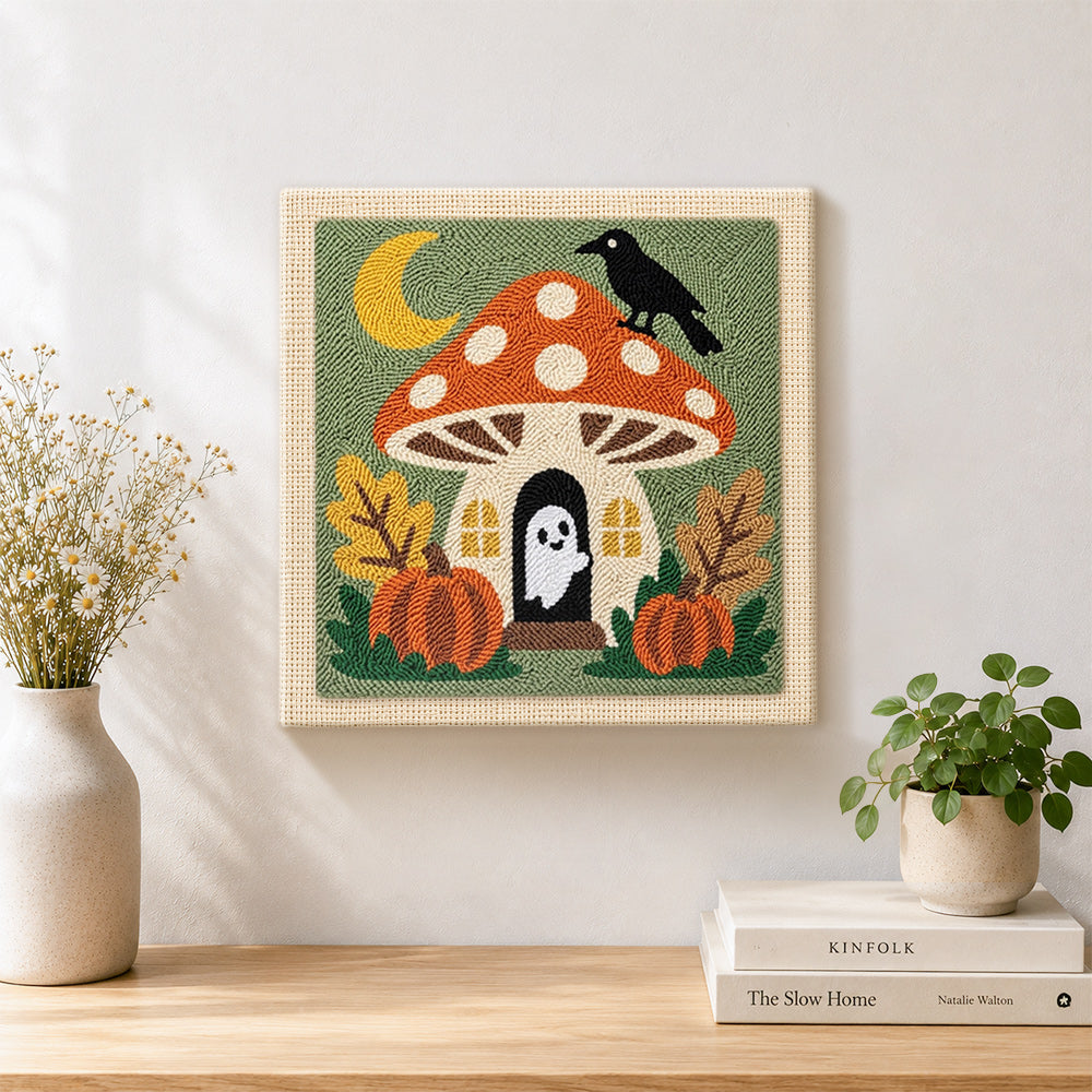 Finished mushroom fairy house with little ghost artwork displayed on a wall