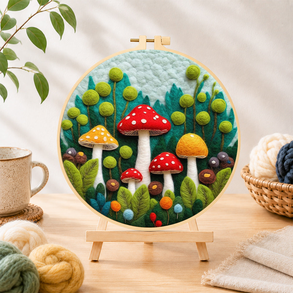 Finished mushroom group in forest needle felting displayed on a wooden easel