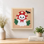 Finished mushroom hat little ghost artwork displayed on a wall