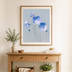 Finished muted blue poppies cross stitch artwork displayed as home decor