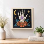 Finished mystic skeleton hand artwork displayed on a wall