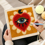 Creating handmade mystical evil eye heart punch needle artwork