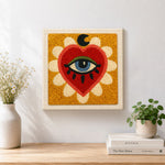 Finished mystical evil eye heart artwork displayed on a wall