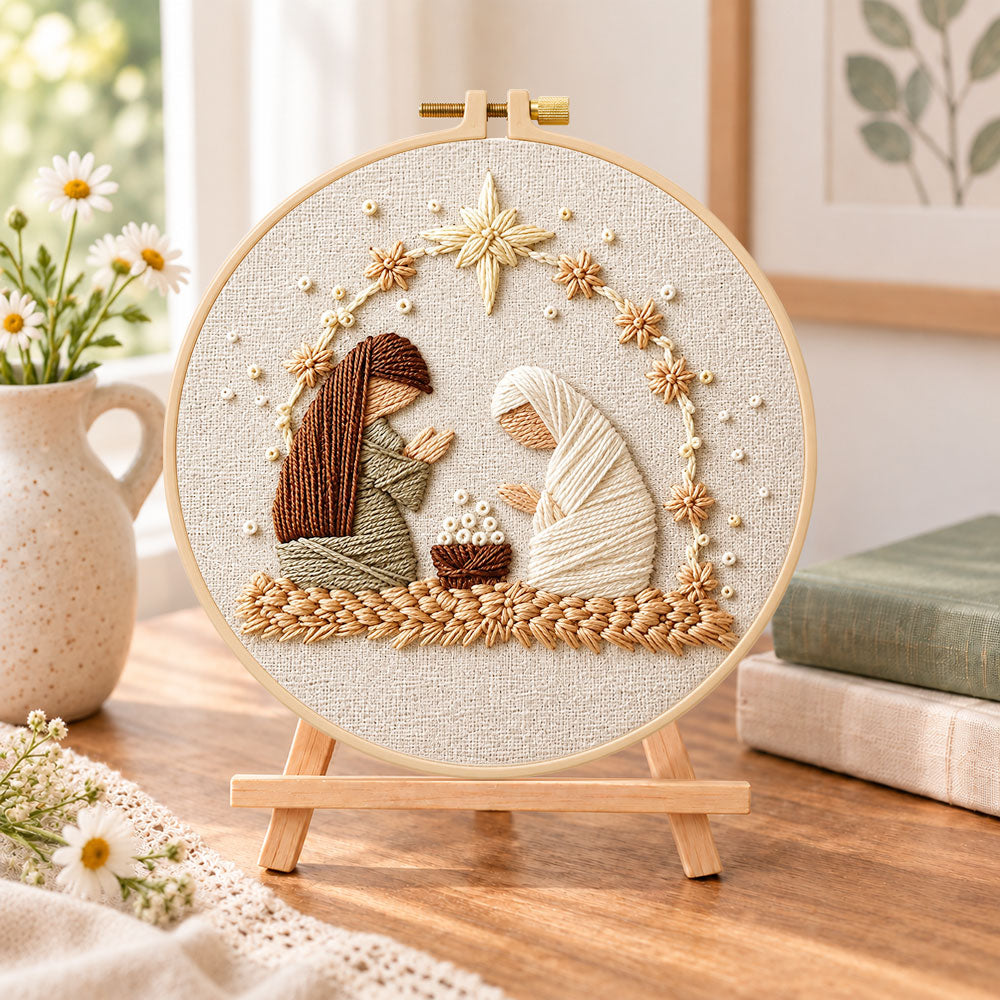 Nativity scene embroidery kit finished hoop displayed on a wooden stand as cozy tabletop decor