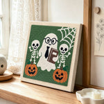 Nerd ghost with skeleton friends punch needle artwork displayed on a table