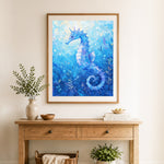 Finished ocean blue seahorse cross stitch artwork displayed as home decor