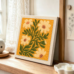 Ochre yellow daisies punch needle artwork displayed on a table