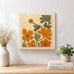 Finished orange and cream flowers artwork displayed on a wall