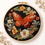 Orange butterfly amid blooms embroidery kit