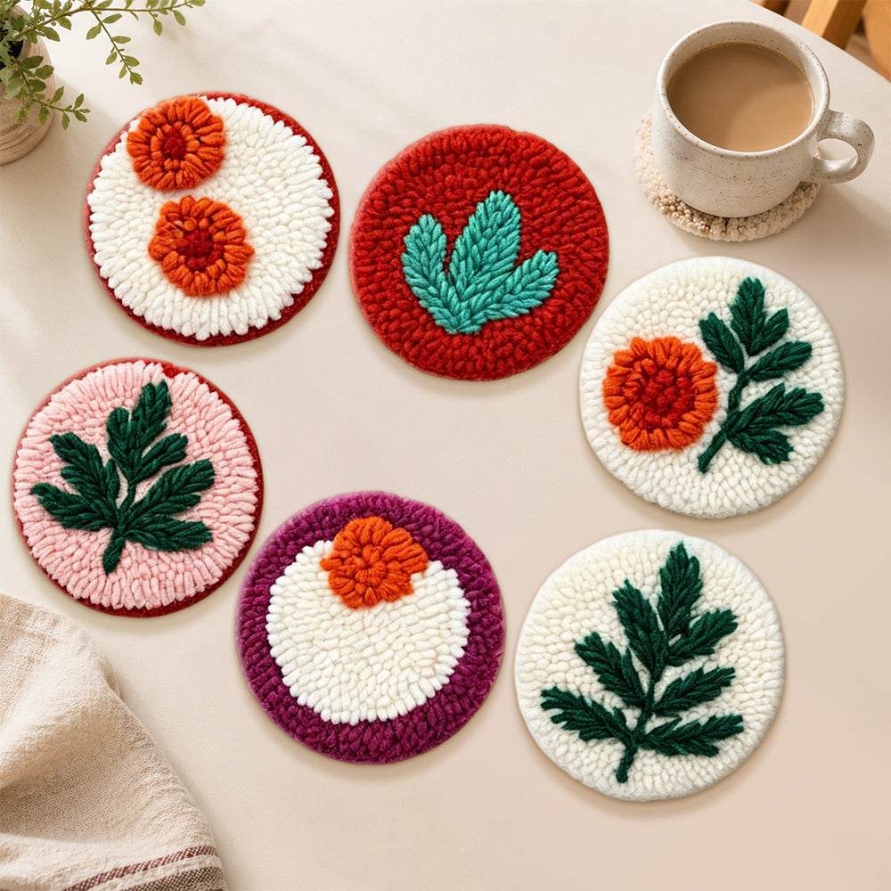 Orange flowers and green leaves punch needle coasters used for home decoration