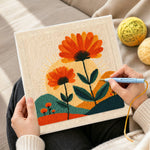 Creating handmade orange flowers and radiant sunset punch needle artwork