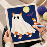 Creating handmade orange ghost cat under full moon punch needle artwork