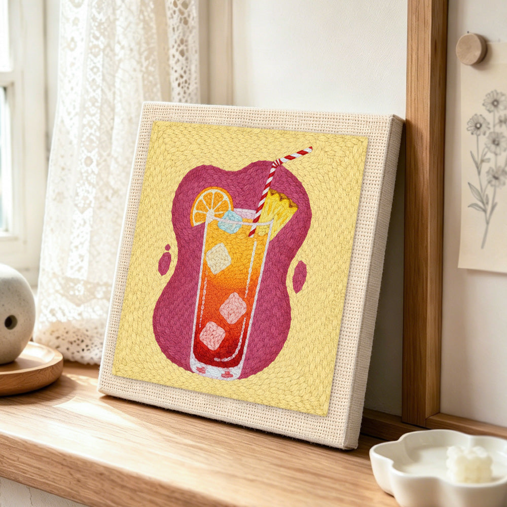 Orange gradient summer drink punch needle artwork displayed on a table