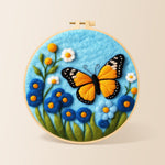 Orange monarch butterfly and blue flowers needle felting kit for beginners with a round wooden frame