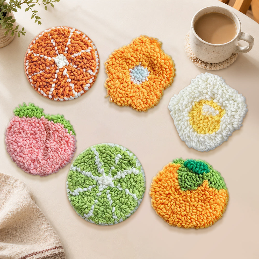 Orange, peach and fried egg punch needle coasters used for home decoration