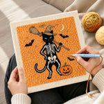 Creating handmade orange skeleton witch cat punch needle artwork