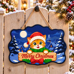 Orange tabby christmas paint by numbers door hanger on a garden gate
