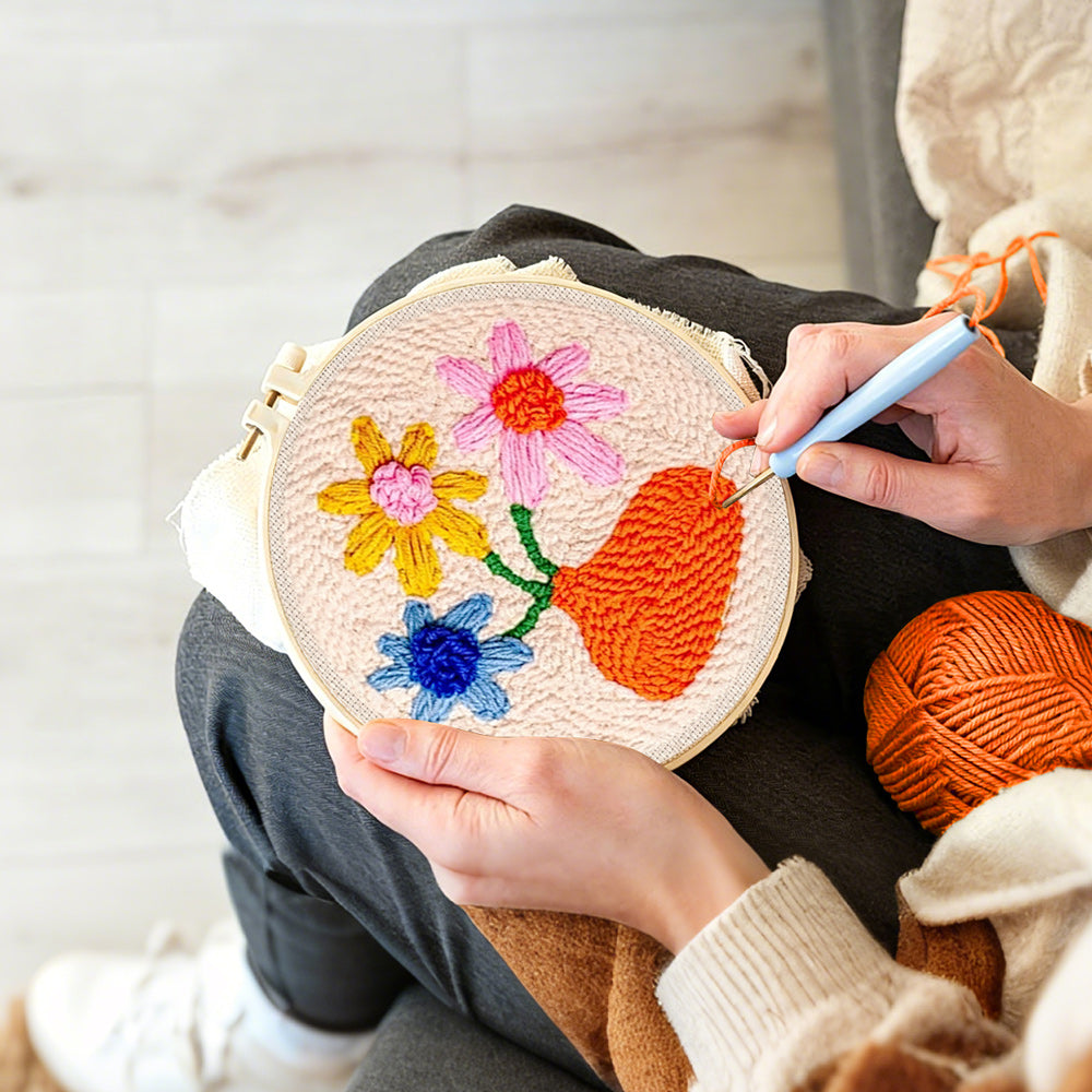 Creating handmade orange vase with colorful flowers punch needle artwork