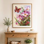 Finished orchid and butterfly cross stitch artwork displayed as home decor