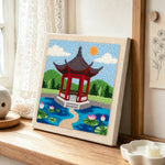 Oriental garden pavilion punch needle artwork displayed on a table