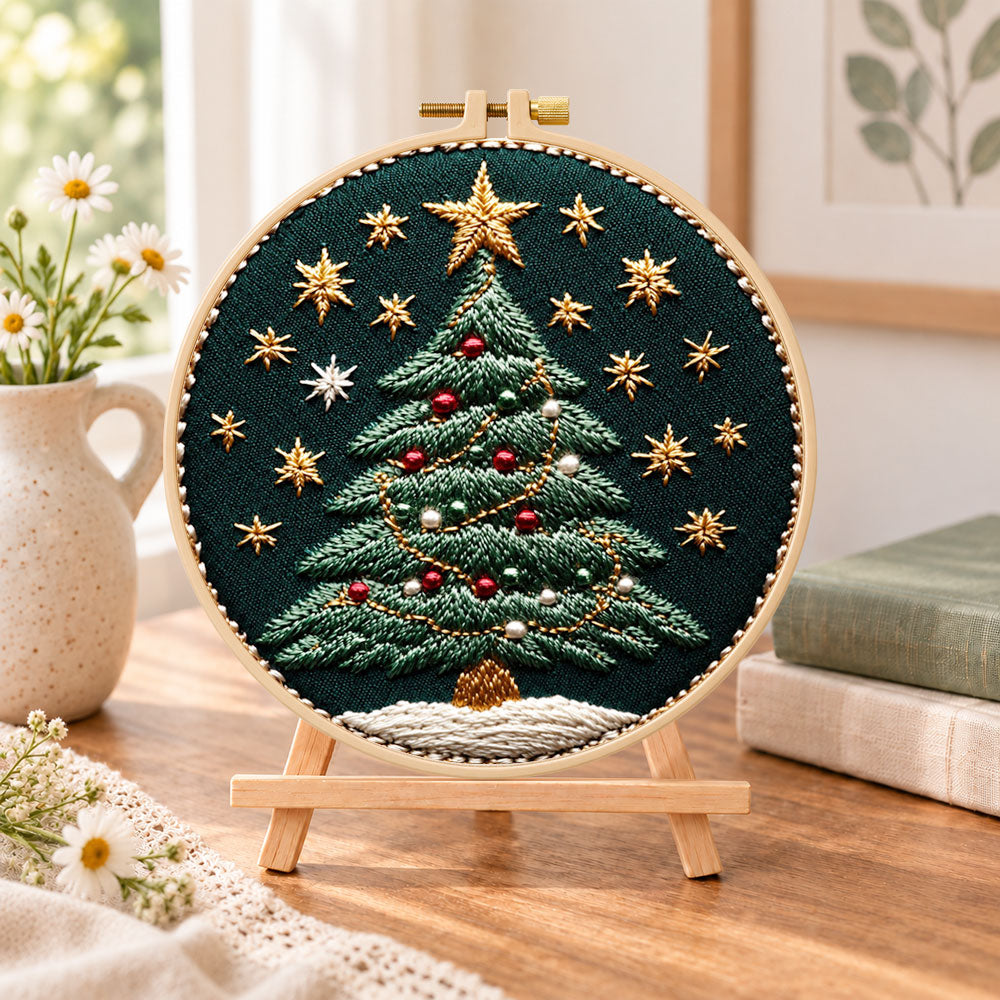 Ornamented christmas tree embroidery kit finished hoop displayed on a wooden stand as cozy tabletop decor
